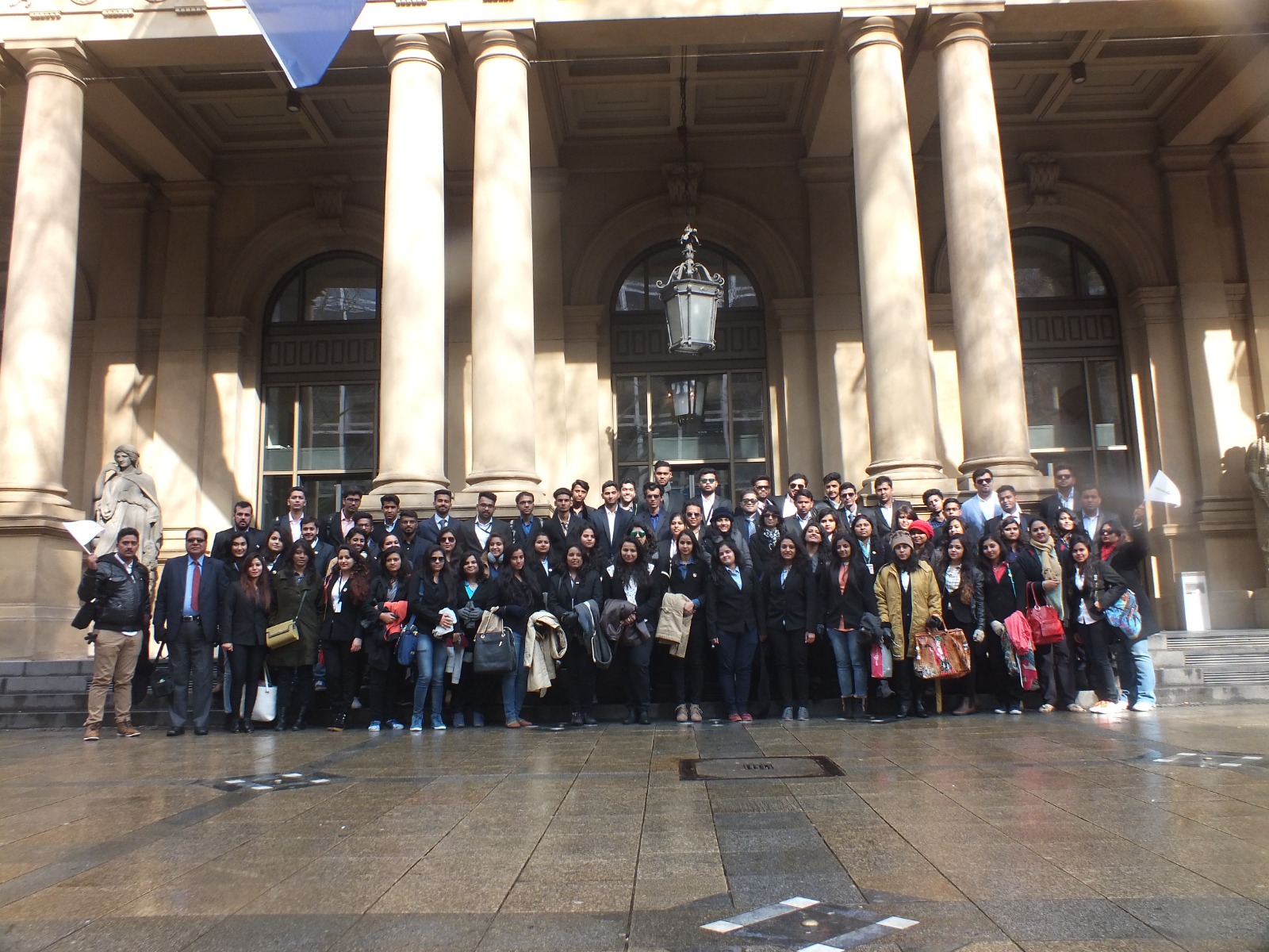 Students and teachers gathered outside a museum during an educational visit