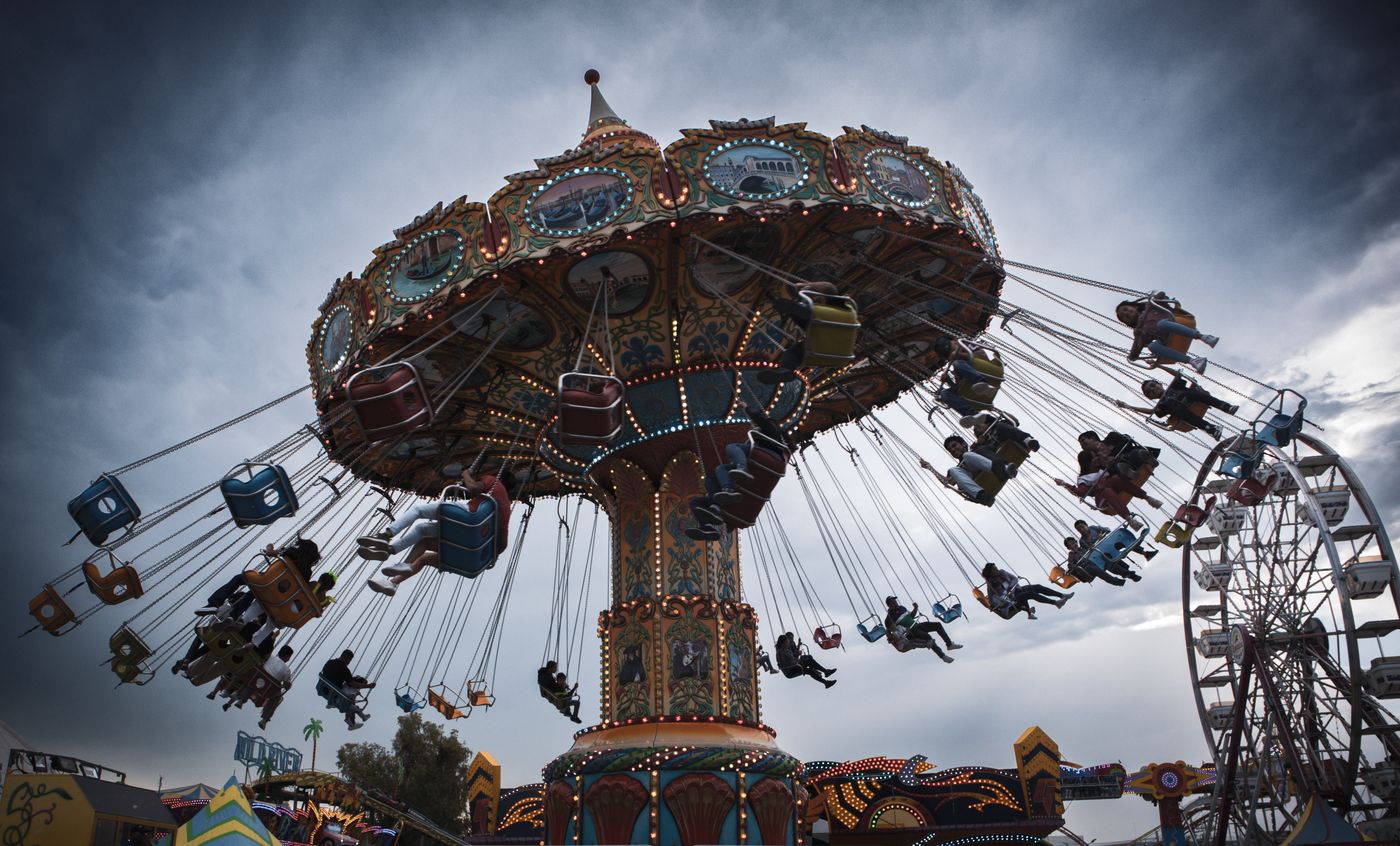 Students enjoying a colorful carnival swing ride